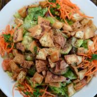 Fattoush · Romaine hearts, tomatoes, cucumbers, carrots, radishes, sliced onion, pita chips, spices, an...
