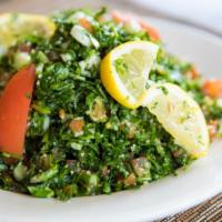 Tabbouleh · Bulgur wheat, tomatoes, parsley, onion, served with lemon and olive oil dressing.