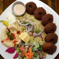 Falafel Plate · Falafel made of garbanzo and fava beans, served with onions, tomatoes and dressed in tahini.