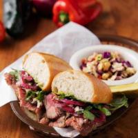 Tri Tip Chimichurri Sub · Hand carved, slow roasted tri tip topped with crumbled Feta, pickled red onion, crisp arugul...
