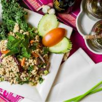 Larb · Ground chicken with roasted rice and spicy lime dressing served with raw cabbage.