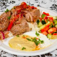 K-3. Lamb Kabob · Two skewers of marinated lamb cooked over fire.