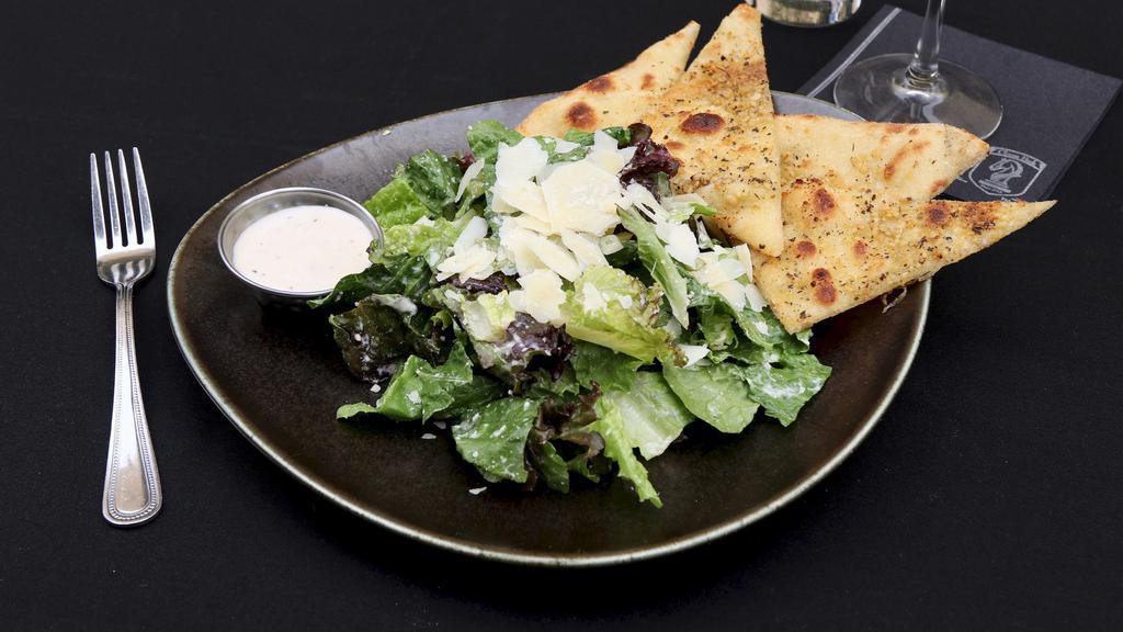 Caesar Salad · Romaine lettuce, shaved parmesan, light Caesar dressing, flat herb bread.