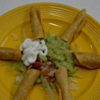 Taquitos Con Guacamole · Rolled hardshell taquitos with guacamole.