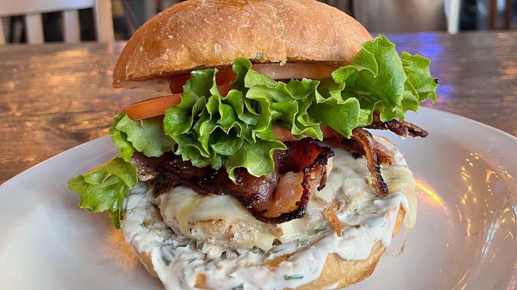 Turkey Bacon Ranch Burger · Turkey patty, applewood-smoked bacon, cheddar cheese, lettuce, tomato, & ranch dressing on an artisan bun.