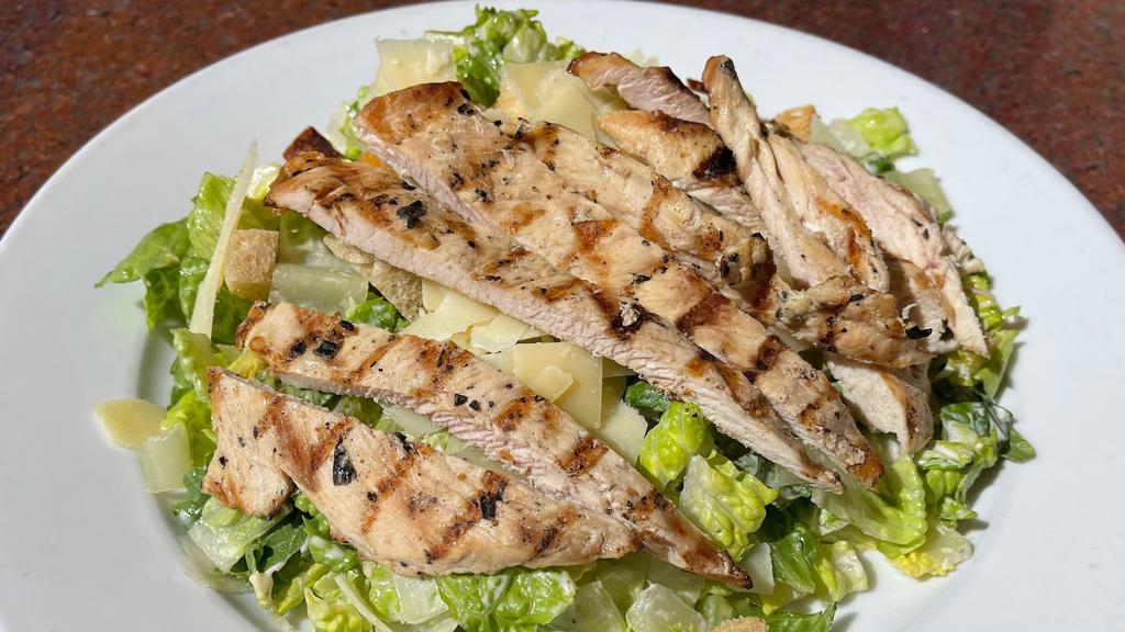Chicken Caesar Salad · Grilled chicken breast, chopped Romaine tossed with Parmesan, garlic croutons & creamy Parmesan dressing (gluten-free).