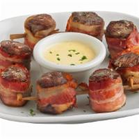 Bacon Wrapped Steak Skewers · Tender, grilled sirloin steak wrapped in savory, smoked bacon. Served with our bleu cheese c...