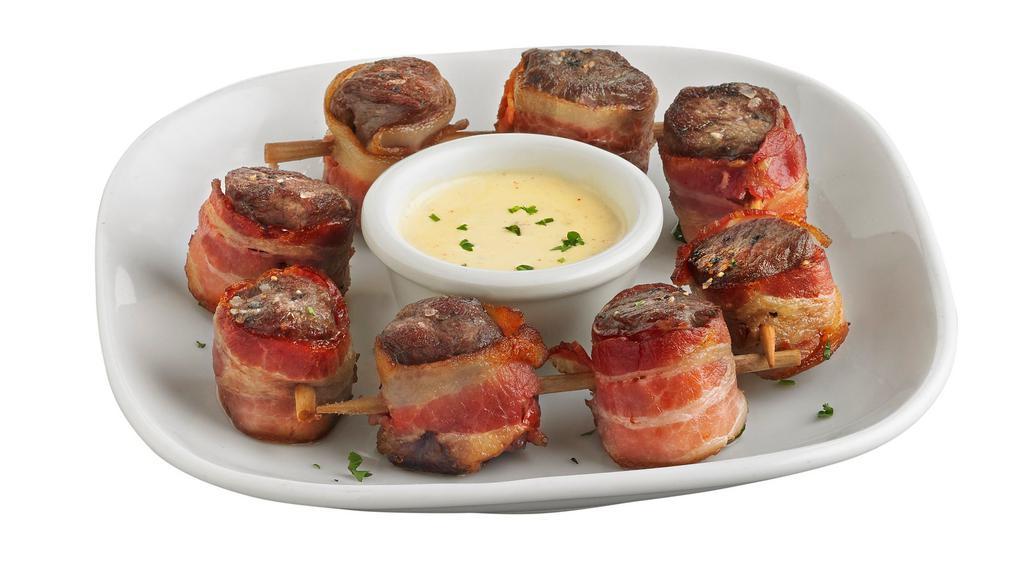 Bacon Wrapped Steak Skewers · Tender, grilled sirloin steak wrapped in savory, smoked bacon. Served with our bleu cheese cream sauce. * 1,050 cal. 
 
*Steak grilled to medium. Consuming raw or undercooked meats may increase your risk of foodborne illness.