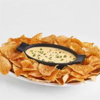 Chips And Queso · Boston's rich queso served with freshly fried and seasoned corn chips.