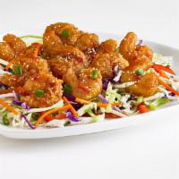 Thai Shrimp Bites · Breaded and fried shrimp tossed in an Asian glaze and served on shredded cabbage. Topped wit...