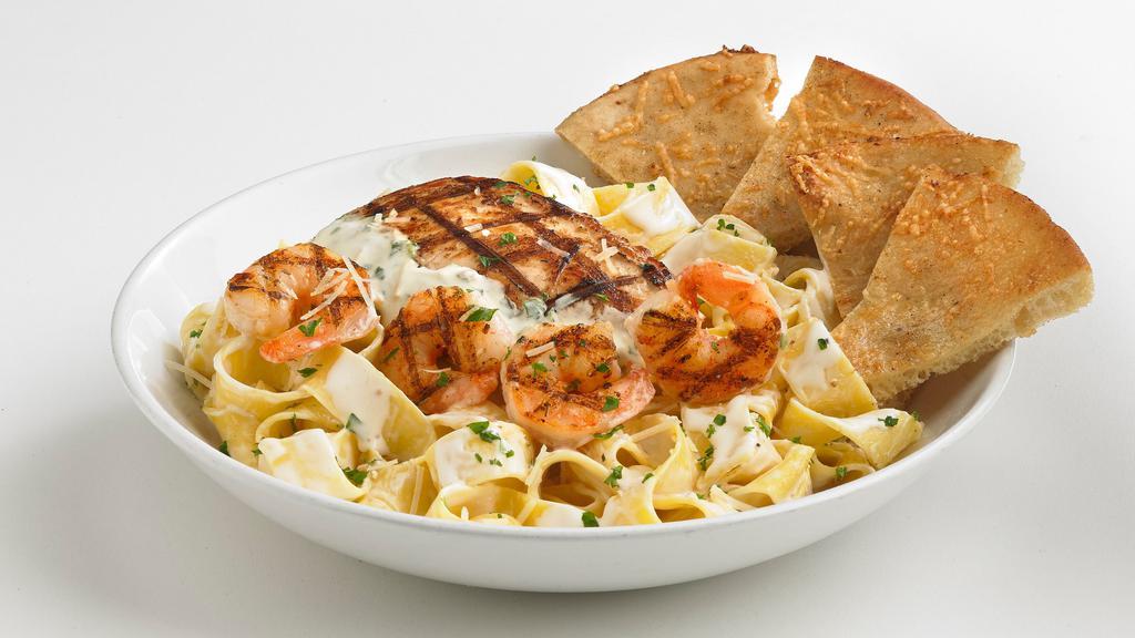 Chicken And Shrimp Pasta · Grilled chicken breast and Cajun shrimp over penne pasta tossed in a creamy Alfredo sauce and finished with lemon-garlic butter.