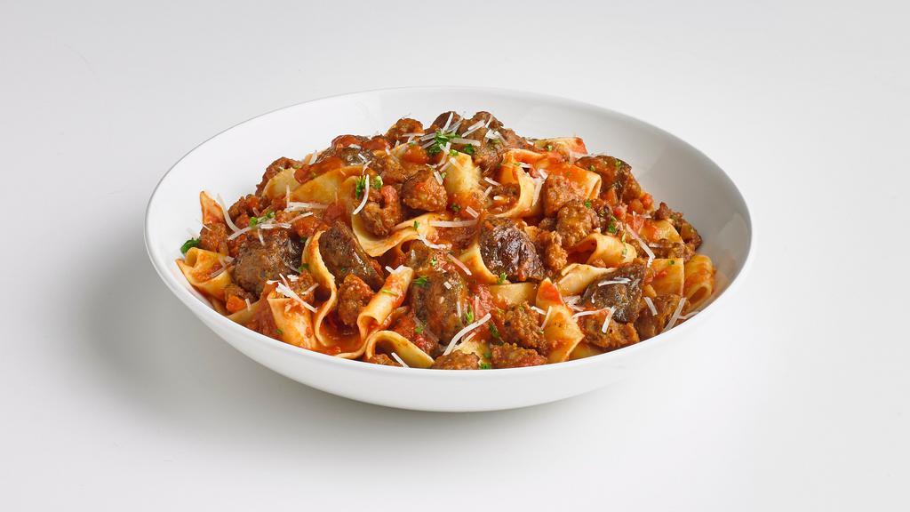 Hungry Carnivore Pasta · Italian sausage, diced meatballs, bacon, pepperoni, and penne pasta smothered in Bolognese sauce.