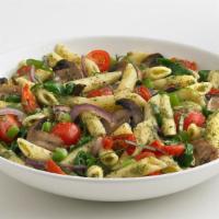Veggie Pesto Pasta† · Penne pasta mixed with an array of seasonal vegetables, tossed in pesto sauce. Topped with f...