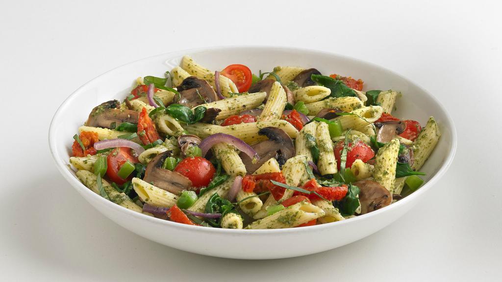 Veggie Pesto Pasta† · Penne pasta mixed with an array of seasonal vegetables, tossed in pesto sauce. Topped with fresh basil.