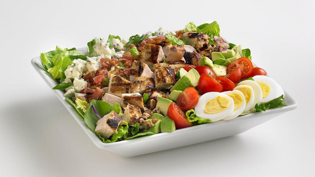 Chicken Cobb Salad · Diced grilled chicken with fresh mixed greens, generously topped with avocado, bleu cheese, bacon, cherry tomatoes, sliced egg, and toasted pecans. Tossed in your choice of dressing.