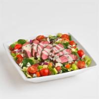Steak Chopped Salad · Tender, grilled steak piled on top of fresh mixed greens tossed, in a balsamic dressing with...