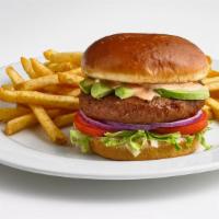 Beyond® Burger · Beyond Meat® 100% plant-based burger patty on top of lettuce, tomatoes, red onions, and slic...