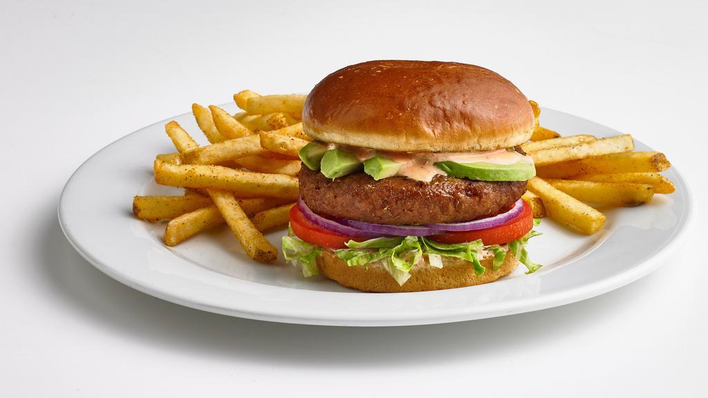 Beyond® Burger · Beyond Meat® 100% plant-based burger patty on top of lettuce, tomatoes, red onions, and sliced avocado. Served on a toasted bun with roasted red pepper aioli.