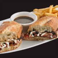 French Dip Sandwich · Thinly sliced roast beef and melted fontina cheese piled high on a toasted hoagie roll. Serv...