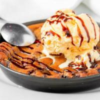 Monster Cookie · A larger than life chocolate chip cookie served hot with a scoop of vanilla ice cream.