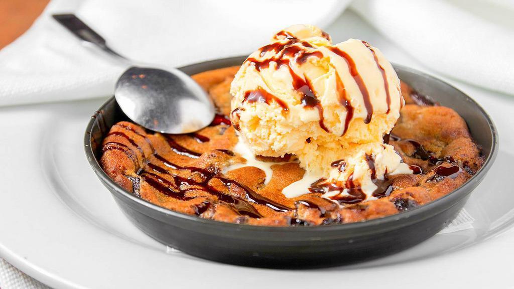 Monster Cookie · A larger than life, chocolate chip cookie served hot with a scoop of vanilla ice cream.