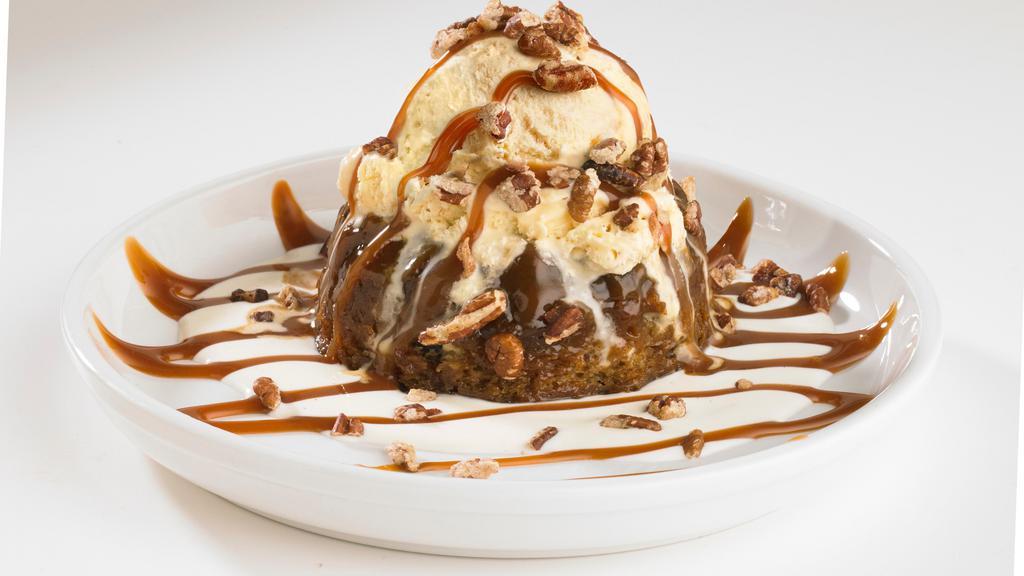 Boston'S Whiskey Cake · This scrumptious sticky toffee pudding cake is surrounded by a decadent whiskey butter sauce and topped with vanilla ice cream. Then it's drizzled in caramel sauce and sprinkled with candied pecans.