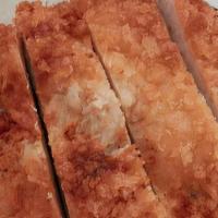 Fried Pork Cutlet · Fried pork tenderloin cutlet with a side of white rice and slaw dressed in rice vinegar and ...