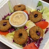 Falafel · Chickpea balls rolled in homemade spices served with a side of hummus.