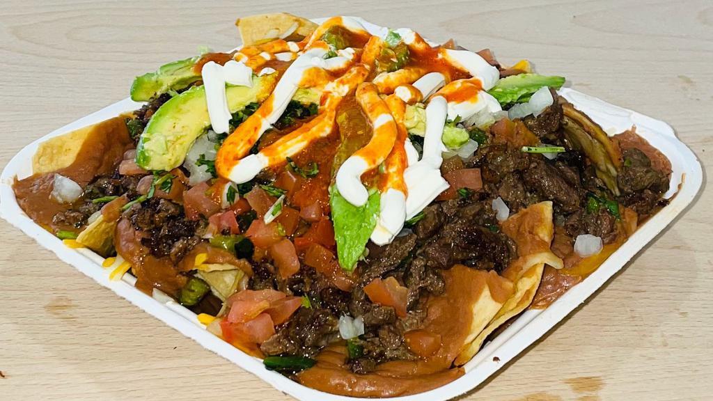 Nacho Loco · Topped with your choice of meat, shredded cheese, tomato, cilantro, sour cream & avocado.