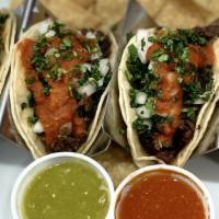 Taco Plate · Tacos with your choice of meat topped with onion, cilantro, salsa with rice and beans.
