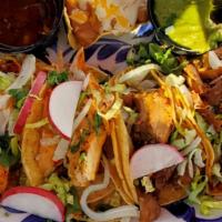 Street Tacos · Four tacos, two grilled pollo asado tacos, and two grilled carnitas tacos, topped with lettu...