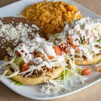 Sopes · Two corn dough sopes with a layer of re-fried beans and choose chicken, carnitas, veggies, o...