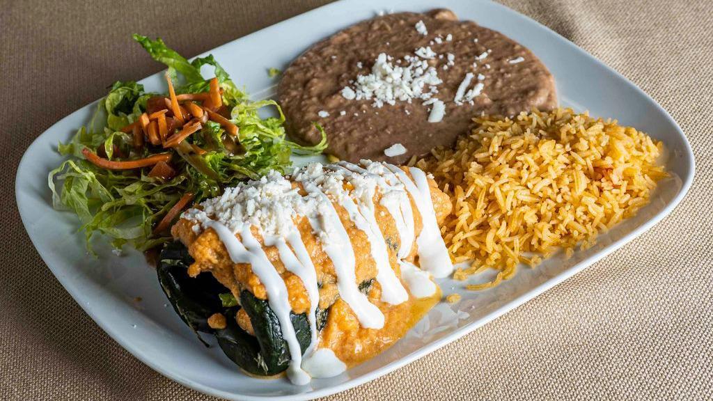 Chile Relleno · Vegetarian, vegan, gluten-free. Our pepper is grilled and steamed (not fried), then stuffed with cheese and your choice of vegetables, chicken, carnitas, or vegan picadillo and covered with a creamy tomato sauce. Served with re-fried beans and rice.