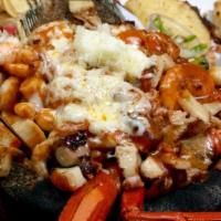 Molcajete De Mariscos · Grilled shrimp, half a tilapia fish, crab, octopus, and scallops. Comes with ranchero sauce ...