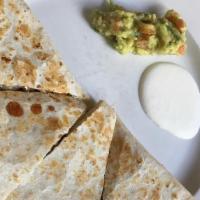 Quesadilla · Flour Tortilla stuffed with cheese, mushrooms, poblano pepper, and caramelized onions, toppe...