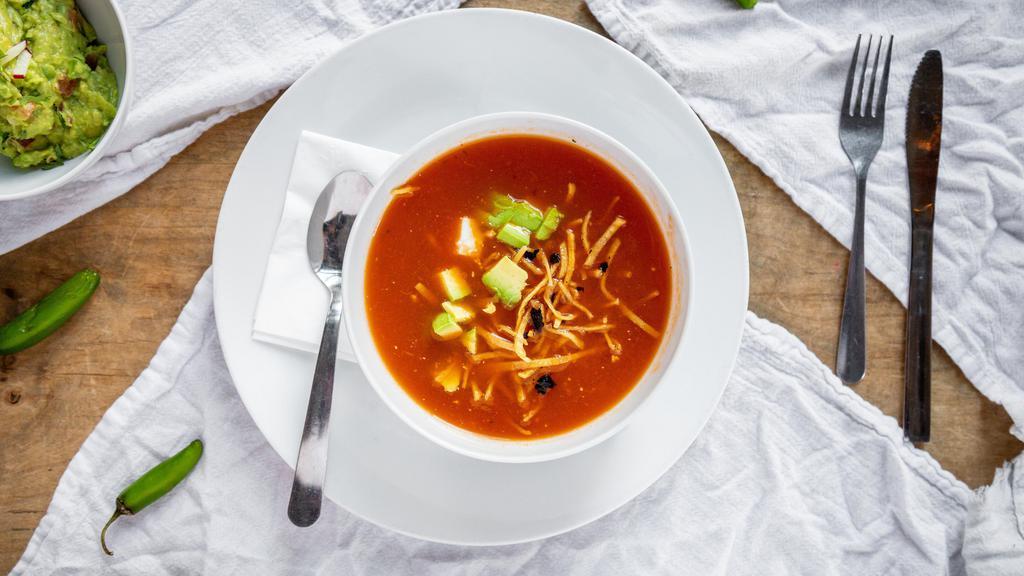 Tortilla Soup · Made with roasted tomatoes, chicken broth, and pasilla chile. Topped with diced avocado, queso fresco, and crispy tortilla strips. Add chicken for an additional charge.