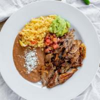 Carnitas · Tender pork served with rice, beans, guacamole, and pico de gallo.