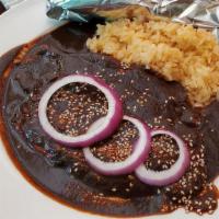 Chicken Mole Poblano · Pan-seared chicken breast with our authentic mole poblano. Served with rice and guacamole. (...