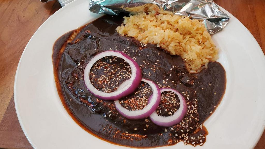 Chicken Mole Poblano · Pan-seared chicken breast with our authentic mole poblano. Served with rice and guacamole. (peanuts).