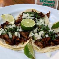 Tacos · Soft corn tortillas, onion, cilantro, salsa.