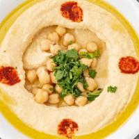 Hummus · Crushed Garbanzo Beans Mixed with Tahini, Lemon Juice and topped with Olive Oil and Paprika....