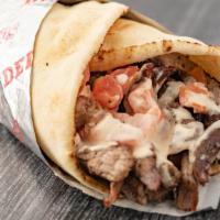 Beef Shawerma Pita · Seasoned Beef slowly grilled on our vertical grill, topped with Lettuce, Tomatoes, Onions an...