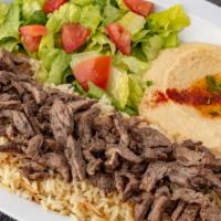 Beef Shawerma Plate (Dinner) · Seasoned Beef slowly grilled on our vertical grill. Served with Hummus, House Salad and Rice.