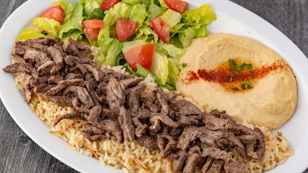 Beef Shawerma Plate (Dinner) · Seasoned Beef slowly grilled on our vertical grill. Served with Hummus, House Salad and Rice.