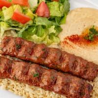 Kafta Kabob (Dinner) · Two Skewers of Marinated Ground Beef Mixed with Chopped Parsley and Onions. Served with Humm...