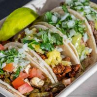 Street Tacos (4) · Choice of meat topped with avocado salsa, onion and cilantro mix in warm corn tortillas stea...