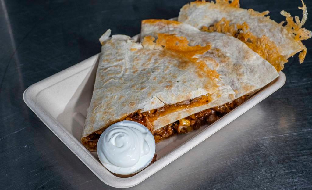 Quesadilla Con Carne · Warm flour tortilla filled with cheese and choice of meat steak, chicken, pork pastor, pork carnitas side of sour cream and avocado salsa.