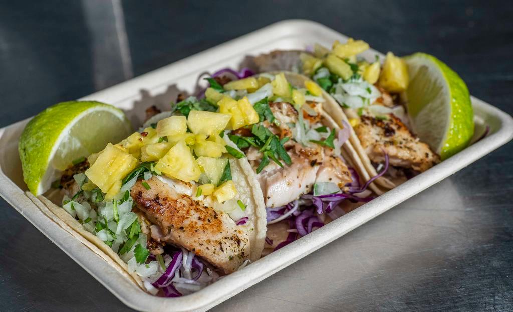 Fish Tacos (3) · Grilled tilapia in a warm corn tortilla topped with shredded cabbage, onion and cilantro mix, avocado salsa and seasonal fruit salsa.
