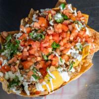 Nachos Street Cravings · Fresh corn tortilla chips topped with cheese sauce, beans, onion and cilantro mix, diced tom...
