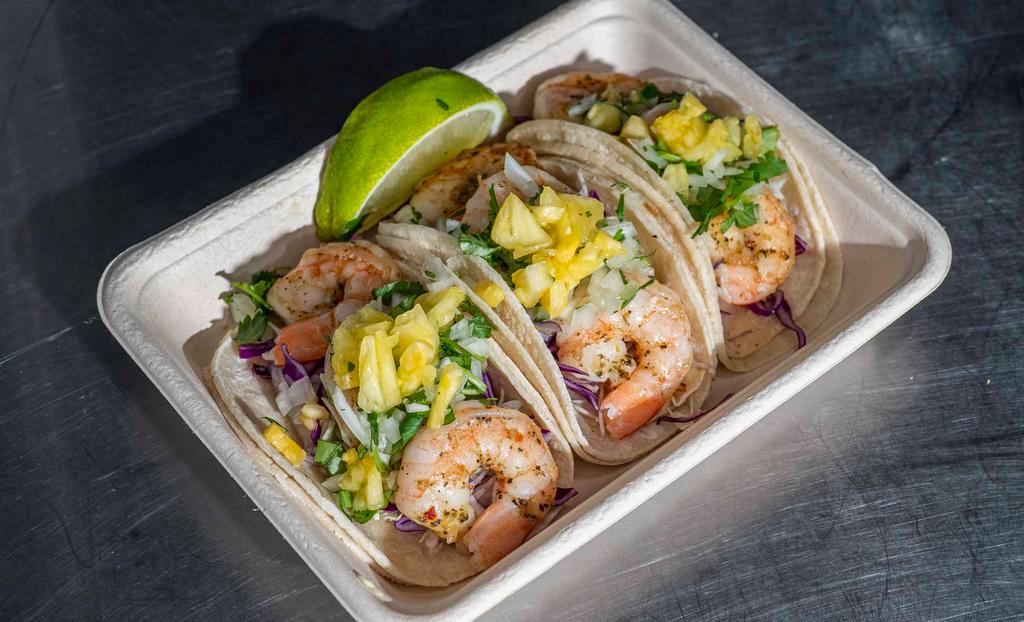 Shrimp Tacos (3) · Grilled shrimp in a warm corn tortilla topped with shredded cabbage, onion and cilantro mix, avocado salsa and seasonal fruit salsa.